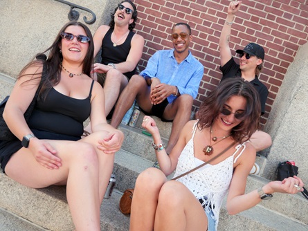 Audience members sing along to Tom Dillon's live karaoke on Pearl Street during the 2026 Cambridge Porchfest.
