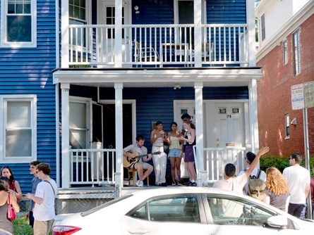 Audience members sing with Tom Dillon (left) for his live karaoke on Pearl Street during the 2026 Cambridge Porchfest.