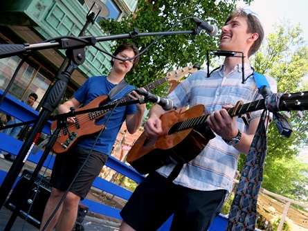 Cooper Smithson (right) performs outside CCTV on Massachusetts Avenue during the 2026 Cambridge Porchfest.