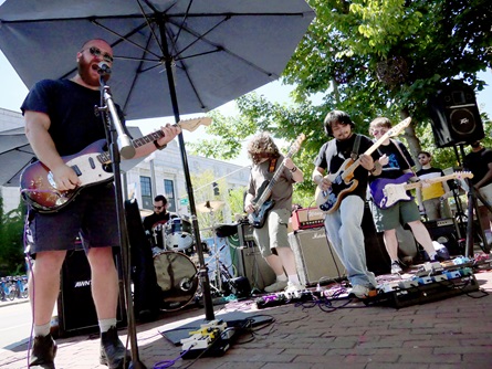 Awnthay perform outside 1369 Coffeehouse on Massachusetts Avenue during the 2026 Cambridge Porchfest.