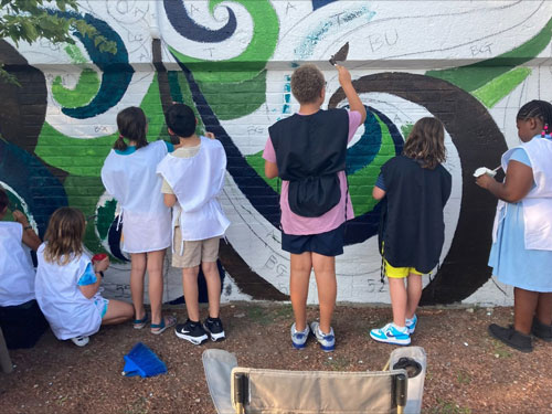 Children help paint the Pemberton Street mural.