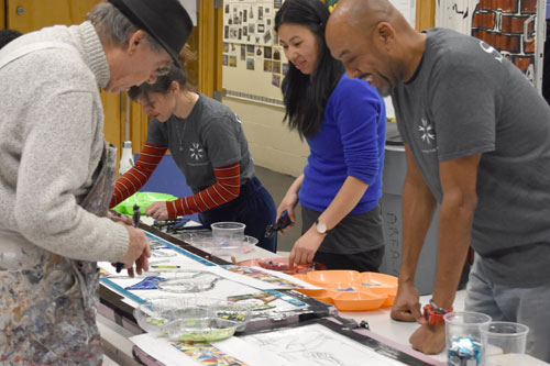 In November 2019, David Fichter (left) worked with guests at Cambridge's Moses Youth Center on the community mosaic for the exterior of the building.