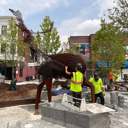 Mark Reigelman's “Edge of the Forest"--a 12-foot-tall steel sculpture of a deer, funded by the City's Percent-for-Art ordinance as part of improvements to Inman Square—was installed in Inman Square on July 18, adding a new landmark to the neighborhood.