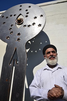 Mahmood Rezaei-Kamalabad, a Cambridge artist and owner of Aladdin Auto Body, poses in front of one of his steel sculptures during Cambridge Open Studios.