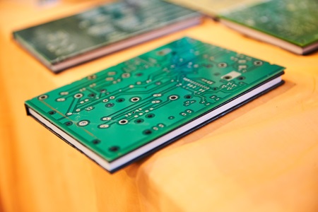 A handmade book made to look like a circuitboard