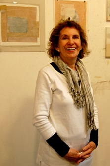 Artist Nina Pattek poses in front of some of her work
