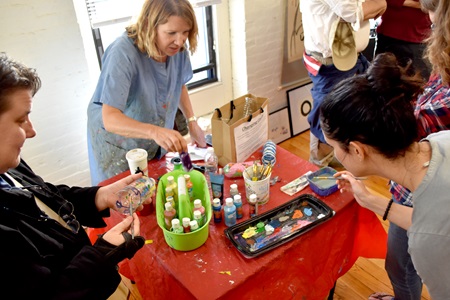 Robyn Hale Reed (center) leads an art making workshop about the plastics polluting the world's oceans at Industry Lab during the 2018 Cambridge Arts Open Studios.
