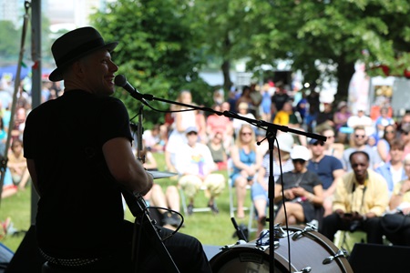 A performer in front of a crowd at River Festival