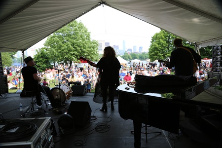 A band performing to a crowd at River Festival