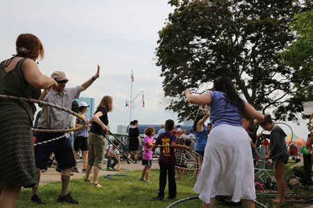 A group of attendees hula-hooping at River Festival