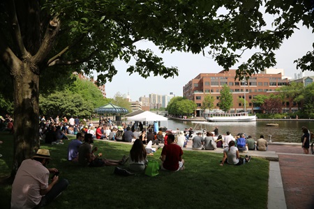 Attendees relaxing by the water at River Festival