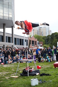 A performing artist displays an incredible acrobatic trick to a crowd