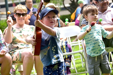 Children play music along with the band Little Groove on 2018 River Festival's Youth & Family Stage.