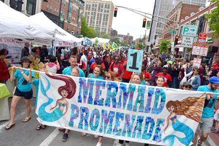 The Mermaid Promenade proceeds down Massachusetts Avenue during the 2019 Cambridge Arts River Festival.