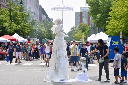Snow, Living Statue performs on Massachusetts Avenue during the 2019 Cambridge Arts River Festival.