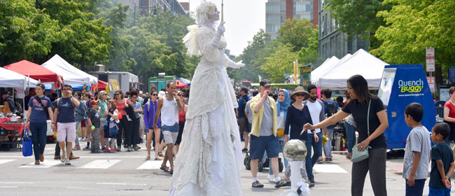 Snow, Living Statue, performs on Massachusetts Avenue during the 2019 Cambridge Arts River Festival.