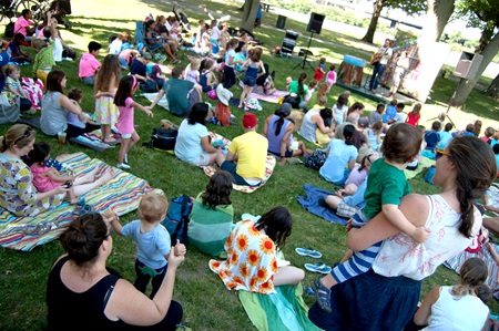 The audience watches Red Yarn perform from the lawn at magazine beach