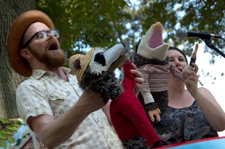 Red Yarn shows their two opossum puppets to the audience