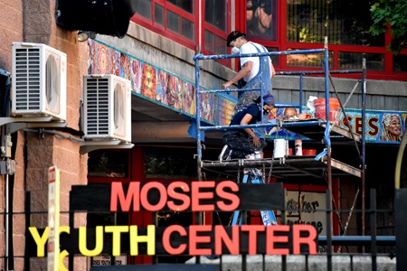 David Fichter (standing) and Xerxes Butt work on his mosaic at Cambridge's Moses Brown Youth Center, July 2020. (Cambridge Arts / Greg Cook)