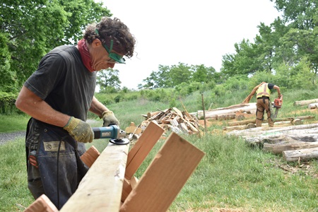 Cabinet maker Billy Locke (foreground) helps Cambridge artist Mitch Ryerson build a Sensory Hilltop for the Universal Design Playground at Cambridge's Danehy Park, June 3, 2021. (Cambridge Arts / Greg Cook)