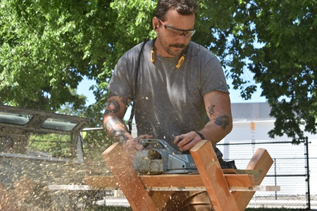 Preparing lumber for a Sensory Hilltop that Cambridge artist Mitch Ryerson is creating for the Universal Design Playground at Cambridge's Danehy Park, July 15, 2021. (Cambridge Arts / Greg Cook)