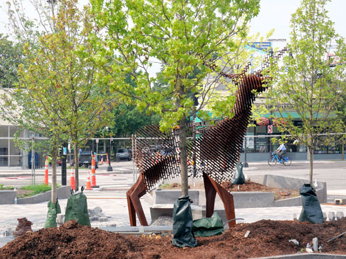 Mark Reigelman's “Edge of the Forest,” a 12-foot-tall steel sculpture of a deer, in Cambridge’s Inman Square, 2023.