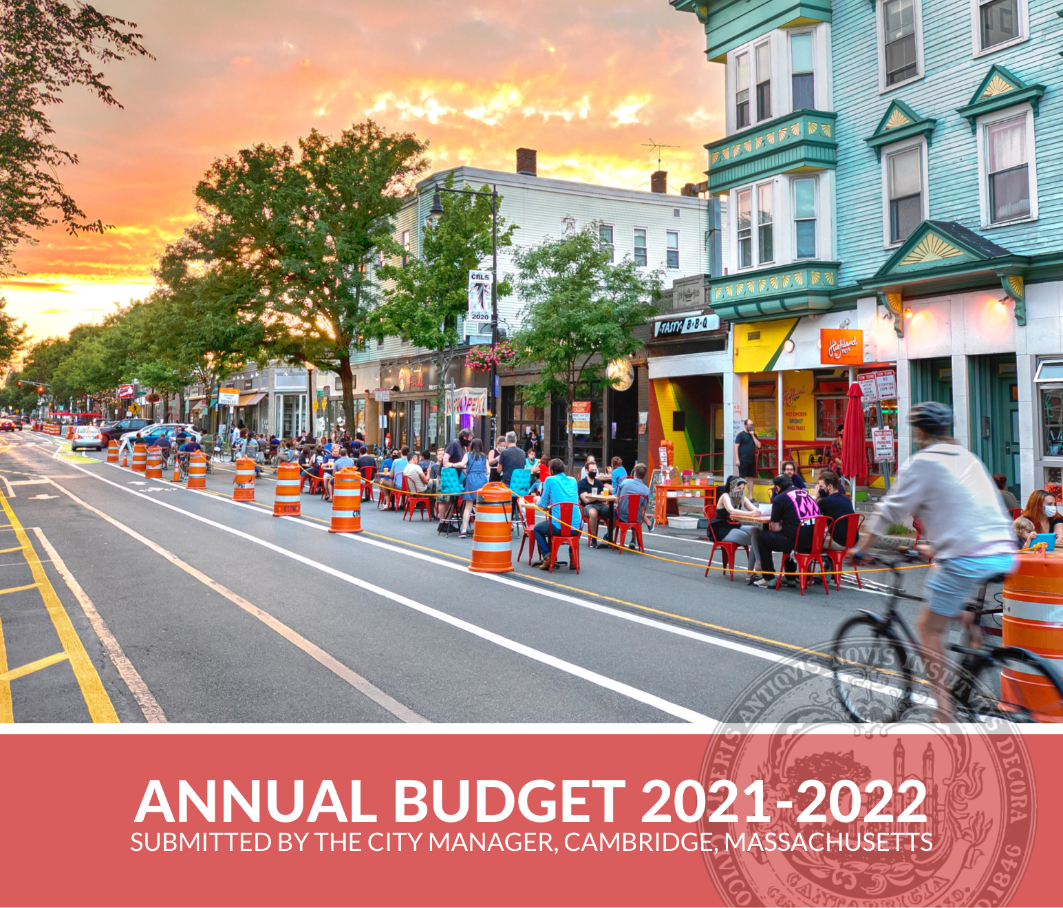 Image of the cover of the FY22 Submitted Annual Budget, including a photo of people dining along Cambridge St. in Inman Square