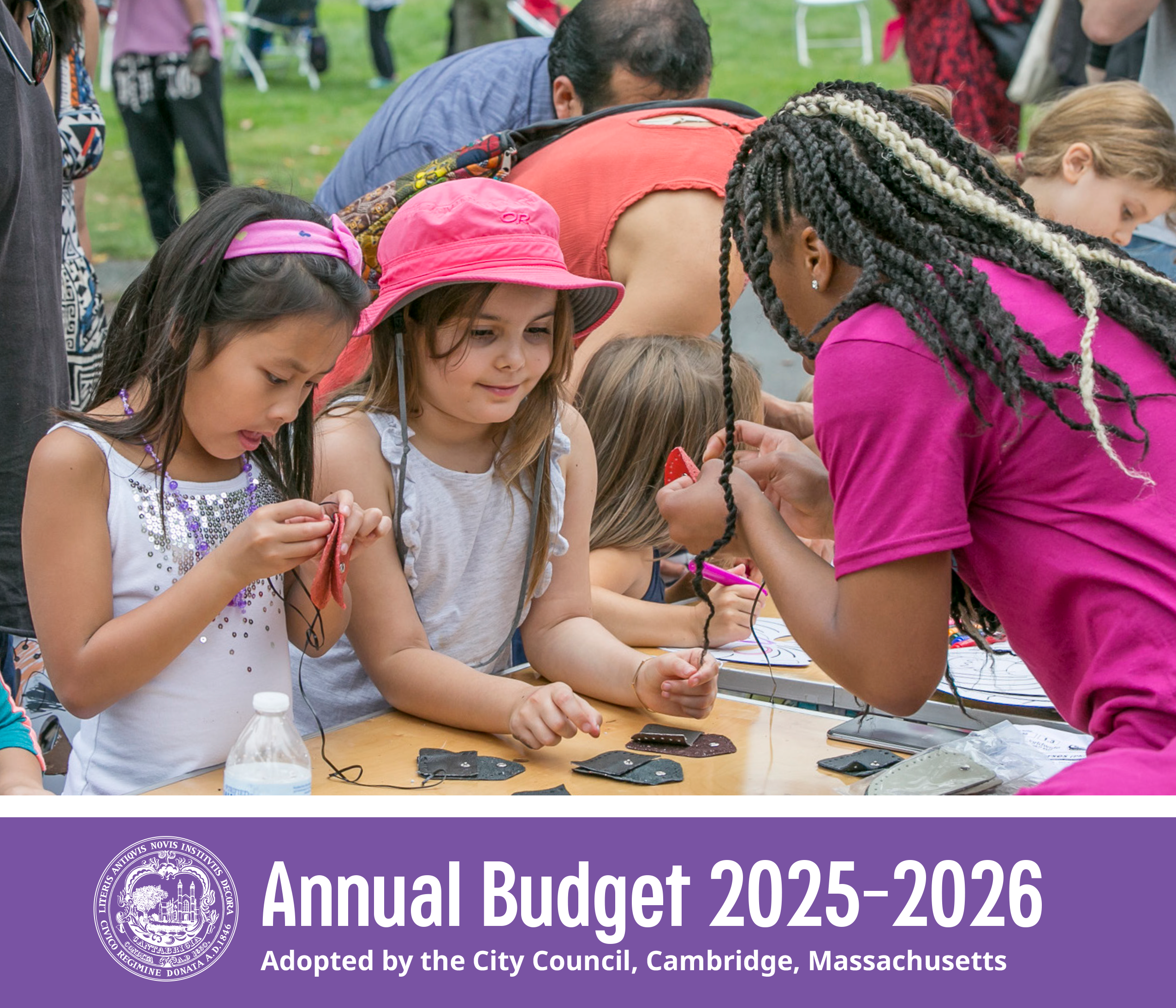 Image from the cover of the FY26 Submitted Budget Book showing a group of children at a crafts table at Danehy Park Family Day