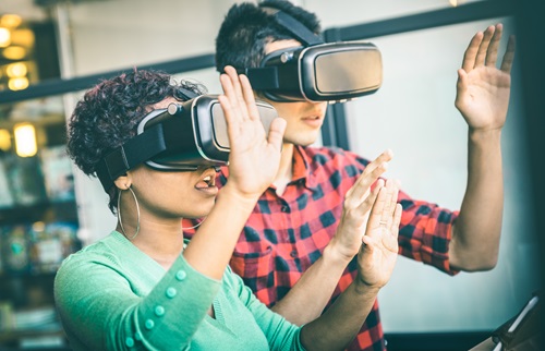Photo of two people wearing VR headsets