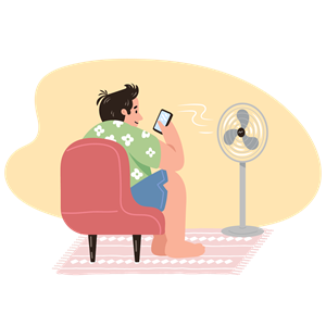 Man playing on his phone in front of a fan