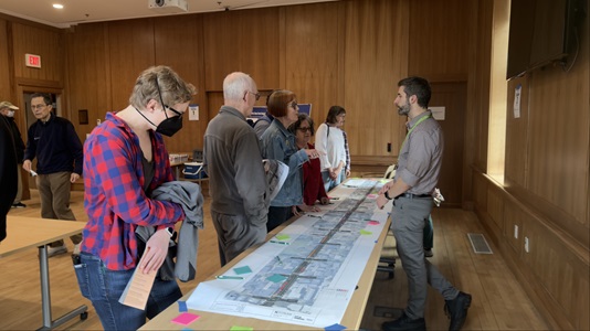 people standing around table with map on it