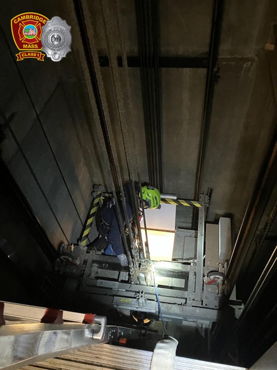 Firefighters working in a blind elevator shaft to rescue a person trapped in a stalled elevator
