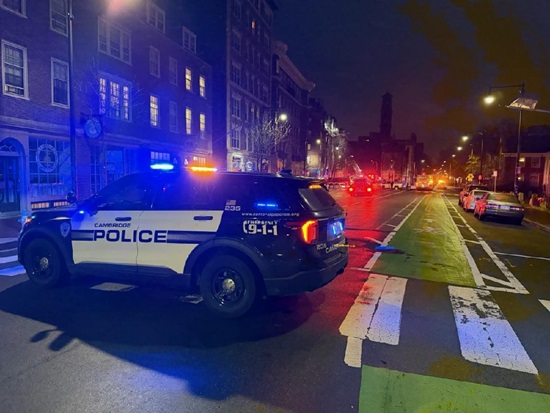 Cambridge Police car located on Mount Auburn St with fire apparatus in the background working at a fire on floor 4
