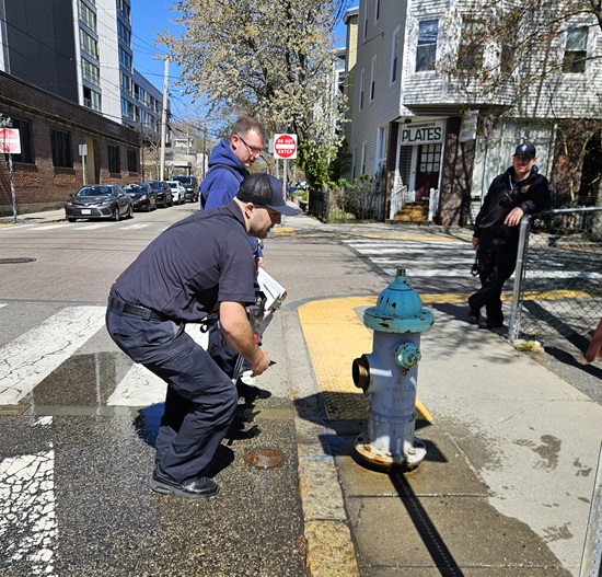 An Engine 6 firefighter checks the hydrant for proper drainage