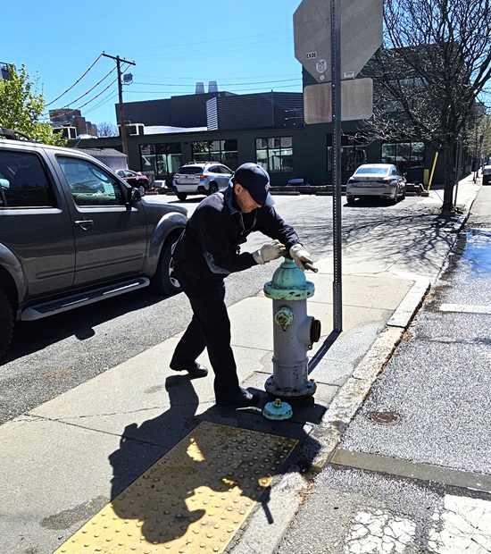 an Engine 6 firefighter opens the hydrant to start water flow