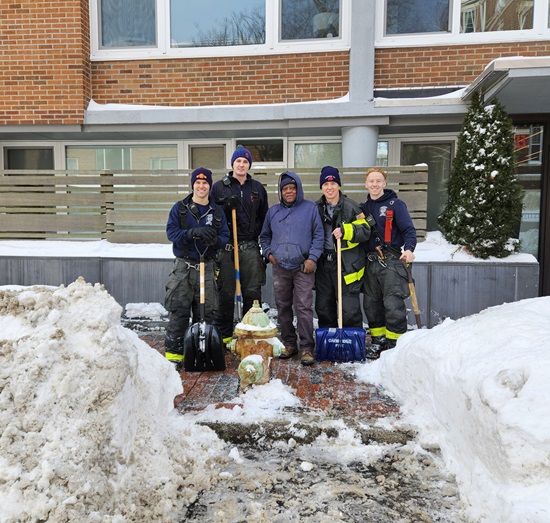 Engine 5 firefighters with a neighbor after clearing snow from a hydrant - January, 2026