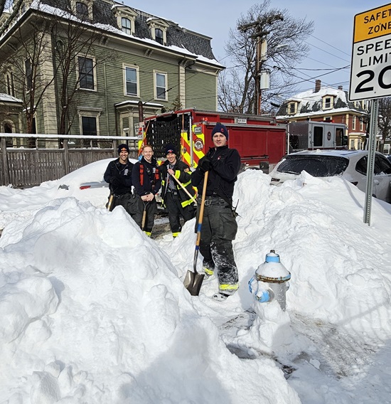 Engine 5 firefighters shoveling snow from a hydrant in their district