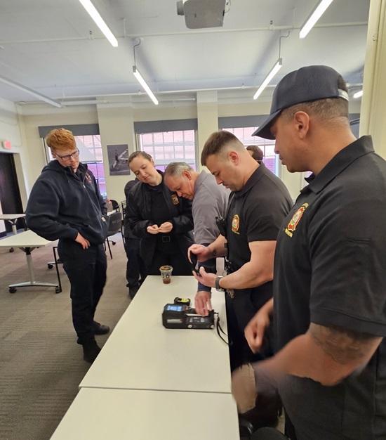 Firefighters using meters to test for radiation source(s)