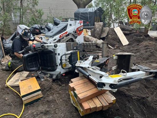 Firefighters using shoring, cribbing, sheeting, hydrauulic and hand tools to extricate a trapped victim at a construction site