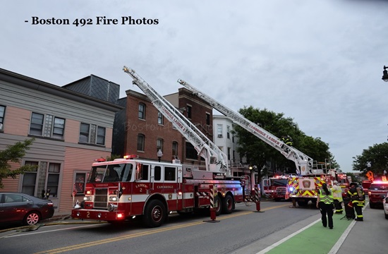 Ladders 2 & 1 aerials to the roof at 803 Cambridge St, a working fire