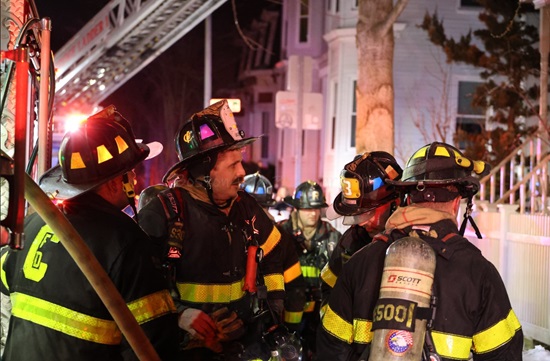 Firefighters making entry to the working fire Box 45-413 on Inman Street