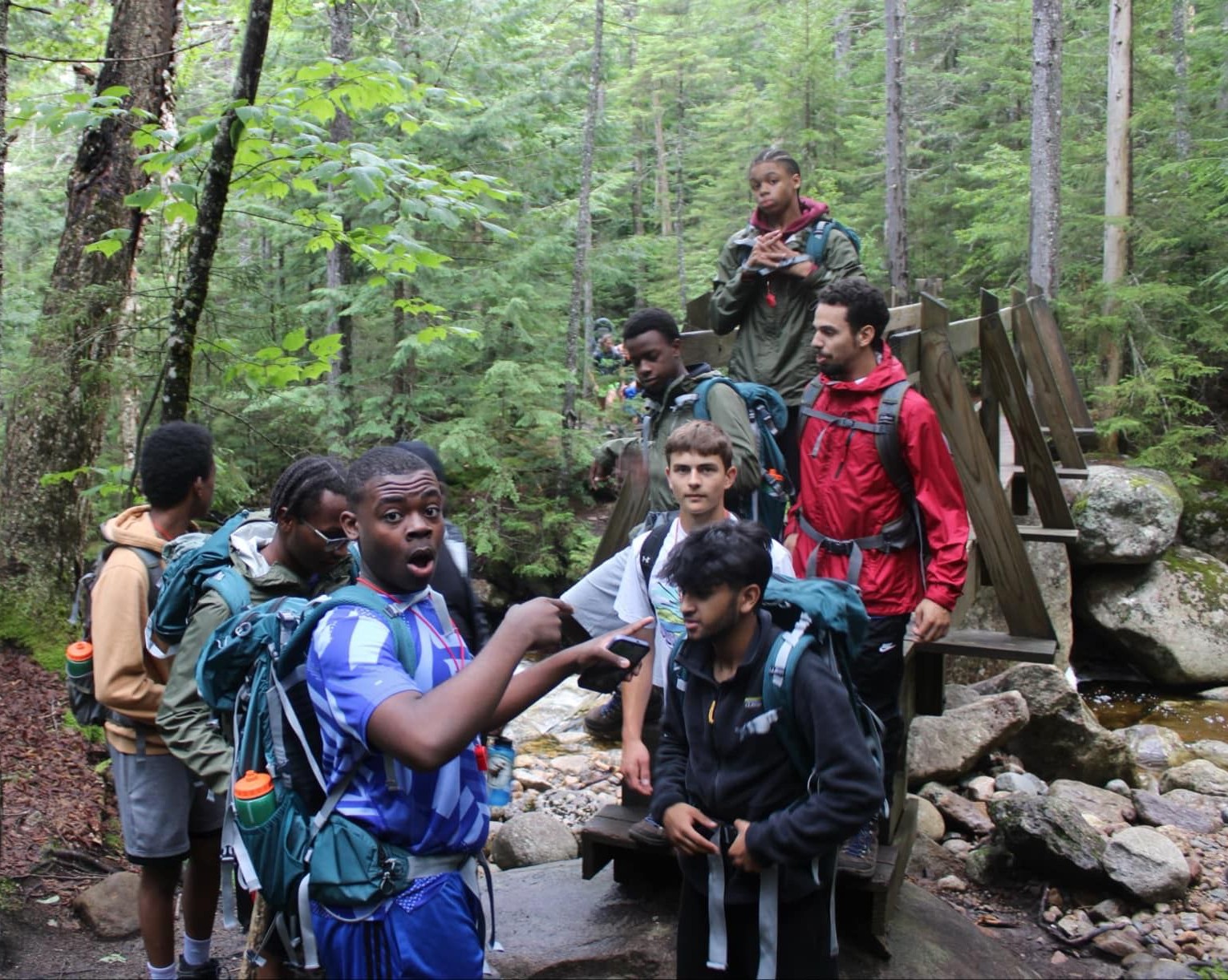 A group of teens during an outdoor activity in the woods