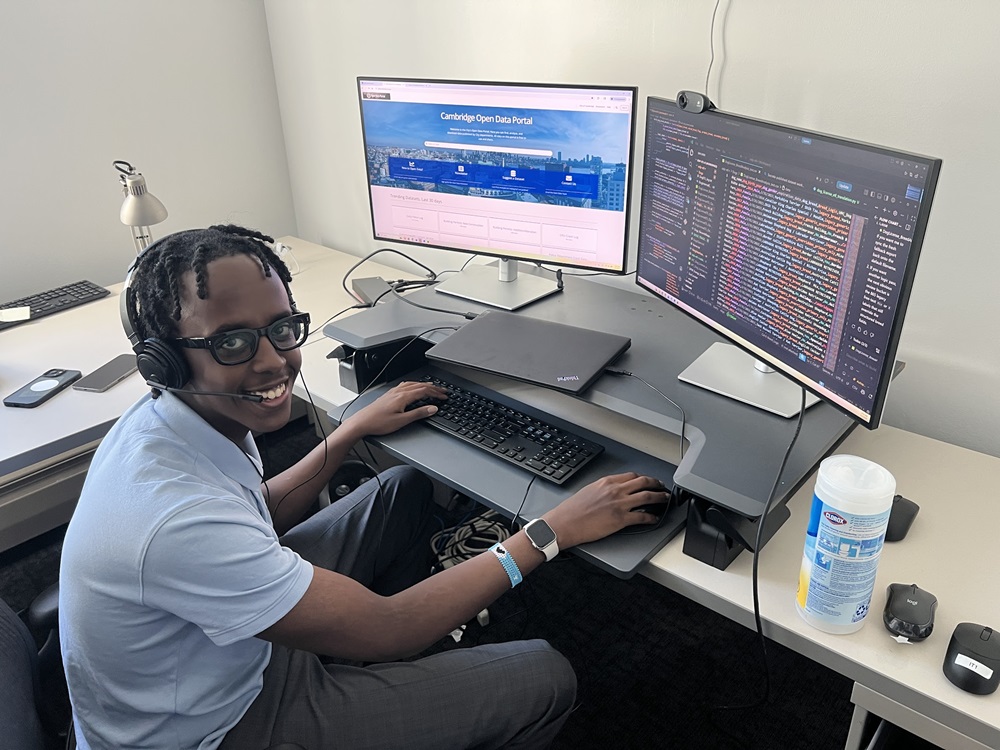 Open Data Intern Mohamud Suleyman sits at a computer