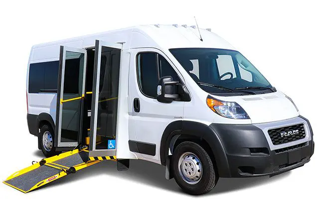 A white van with an open door and an accessible ramp fully extended.