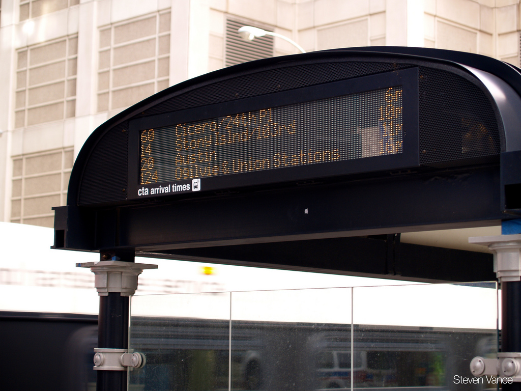 Bus shelter with integrated arrival time monitor