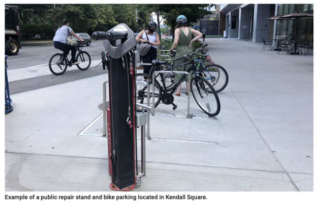A bike repair station, with a variety of tools and a tire pump attached.