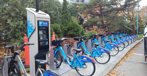 A Bluebikes docking station with bikes available to rent.