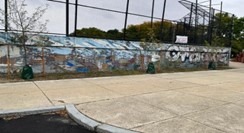 A fading mural.  It is hard to make out the subject of the mural, although it appears to say "Cambridge" in big letters on one side.