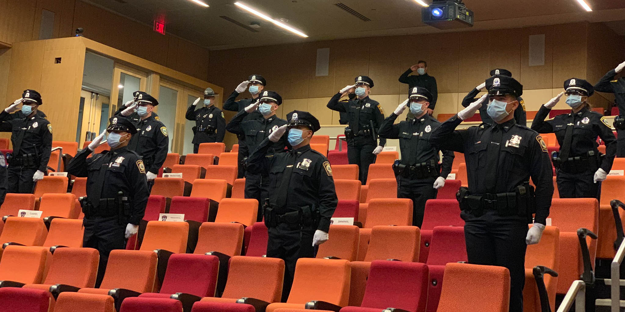 Officers saluting in a classroom