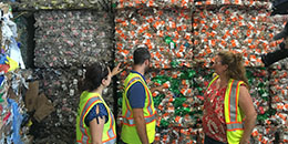 DPW workers in front of cans ready for recycling